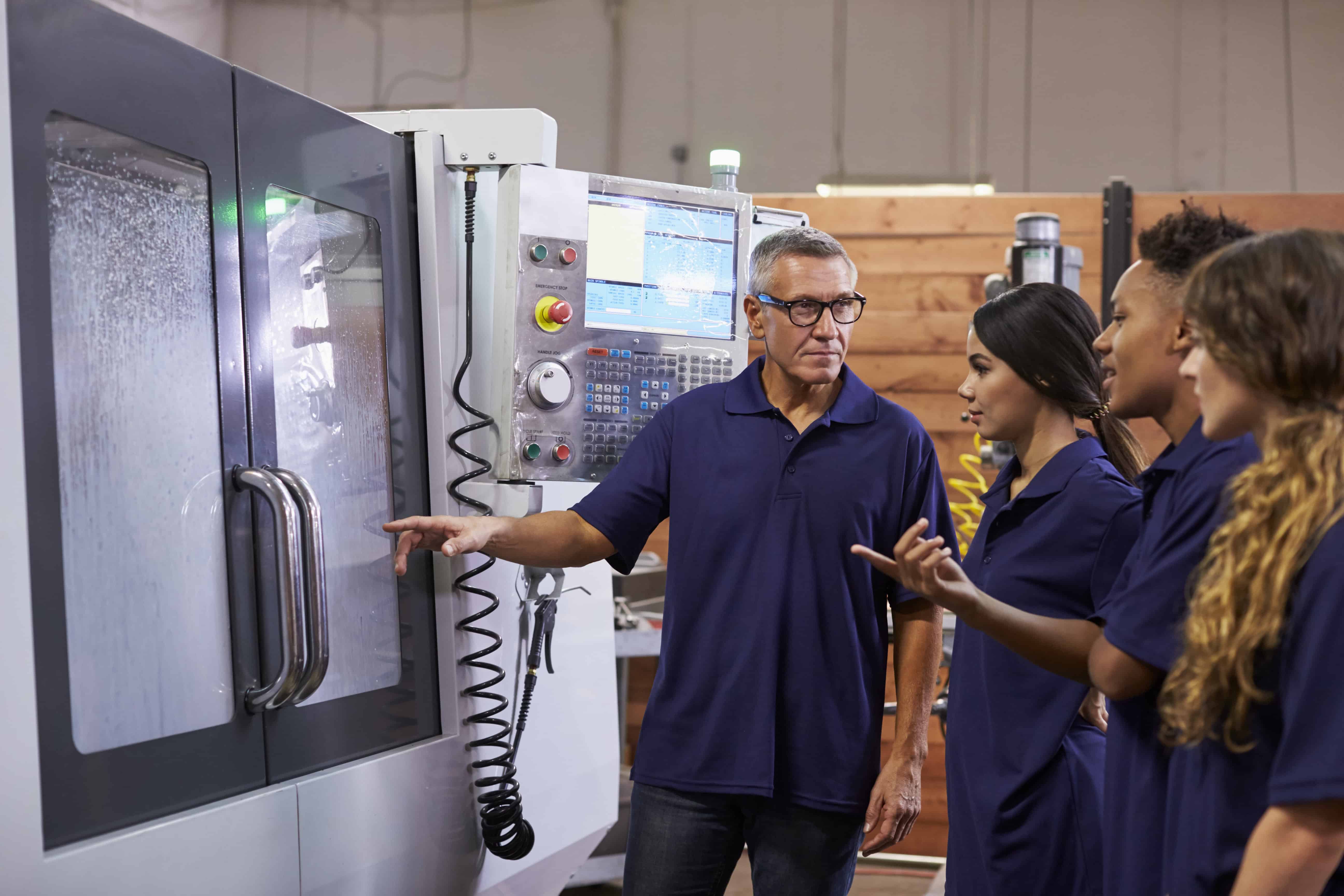 Apprentices training on a CNC machine