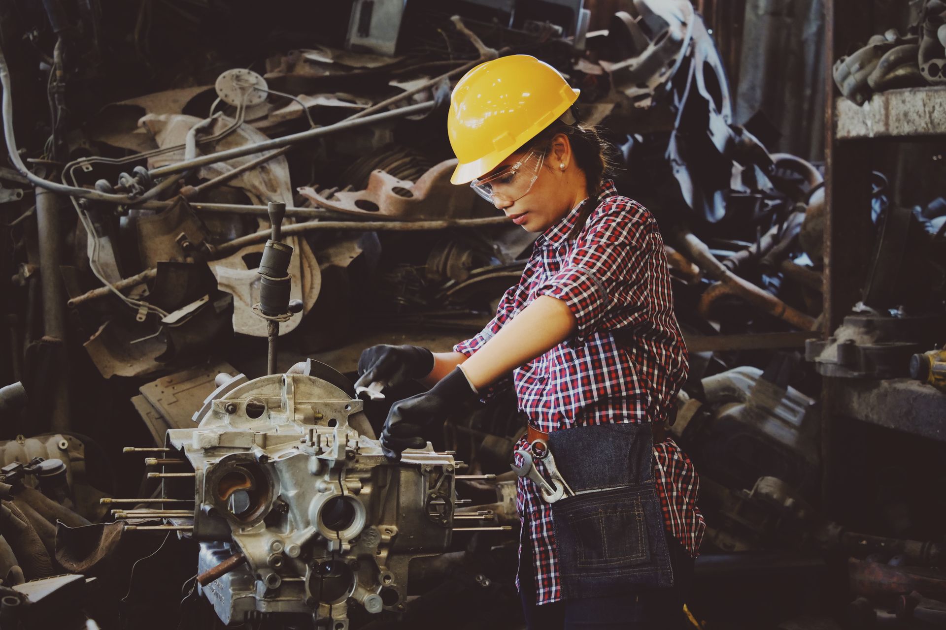 Woman machinist working on industrial equipment